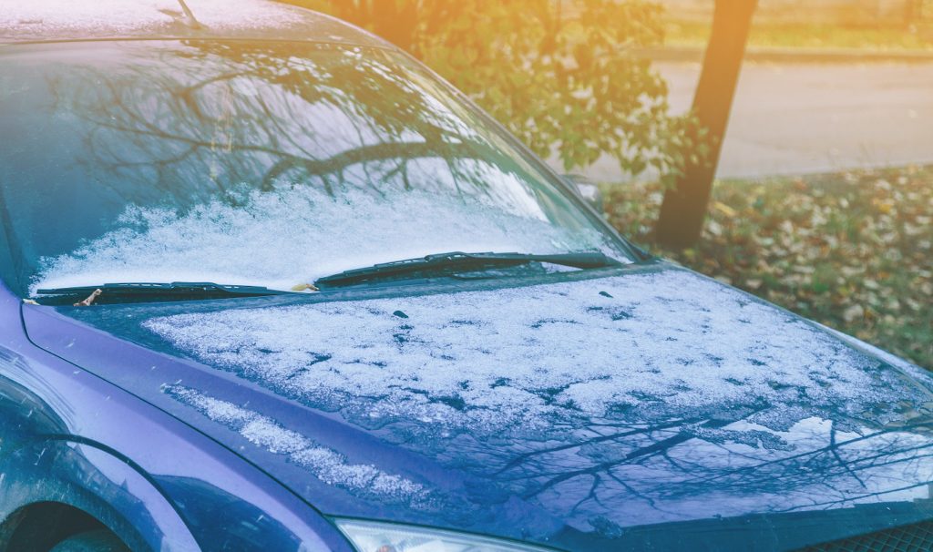 blue car with hail damage on the hood that needs hail damage repair