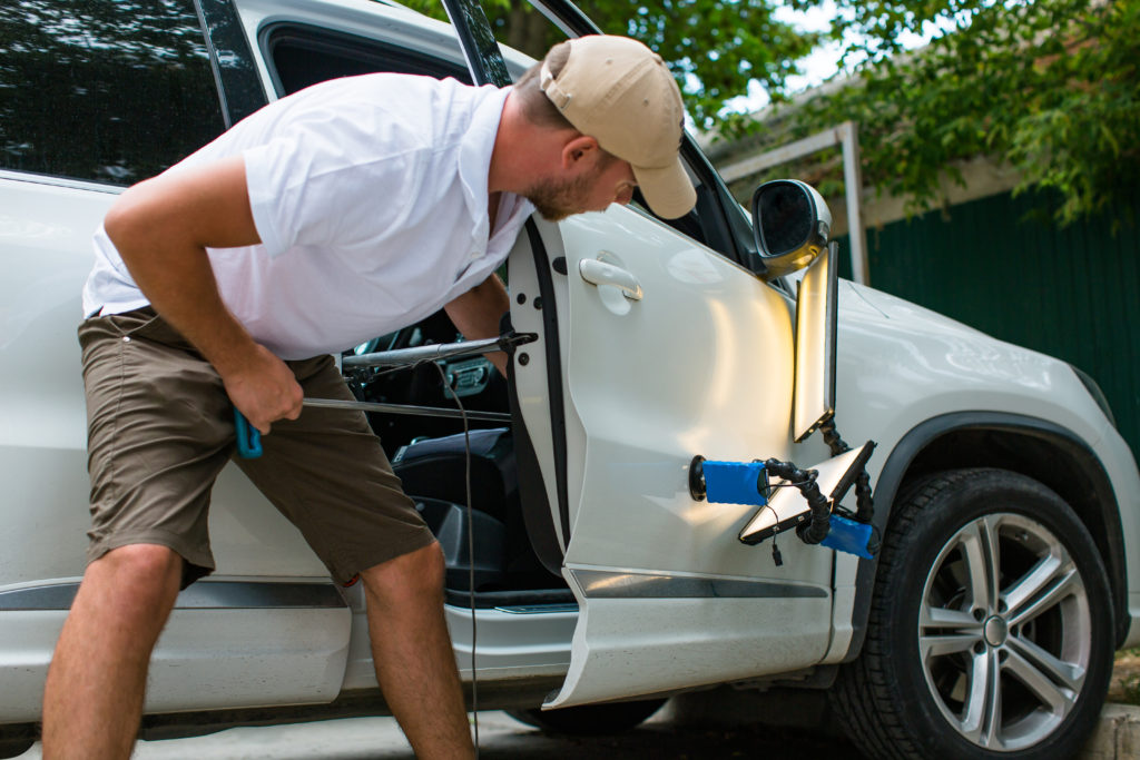 Repairing car dent after the accident by paintless dent repair I