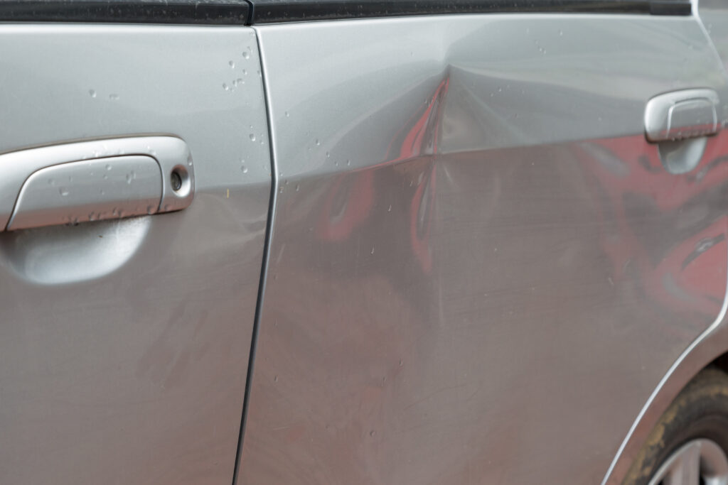 Door car with damage on accident with dent on left side on raining day