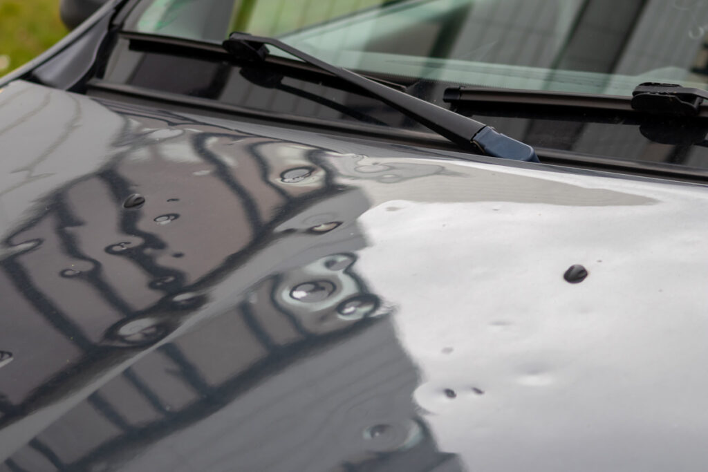 A hood of car that has been damaged by hail in El Paso.